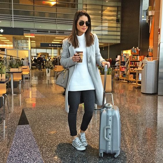 black denim, a white sweater, a grey coat and grey sneakers