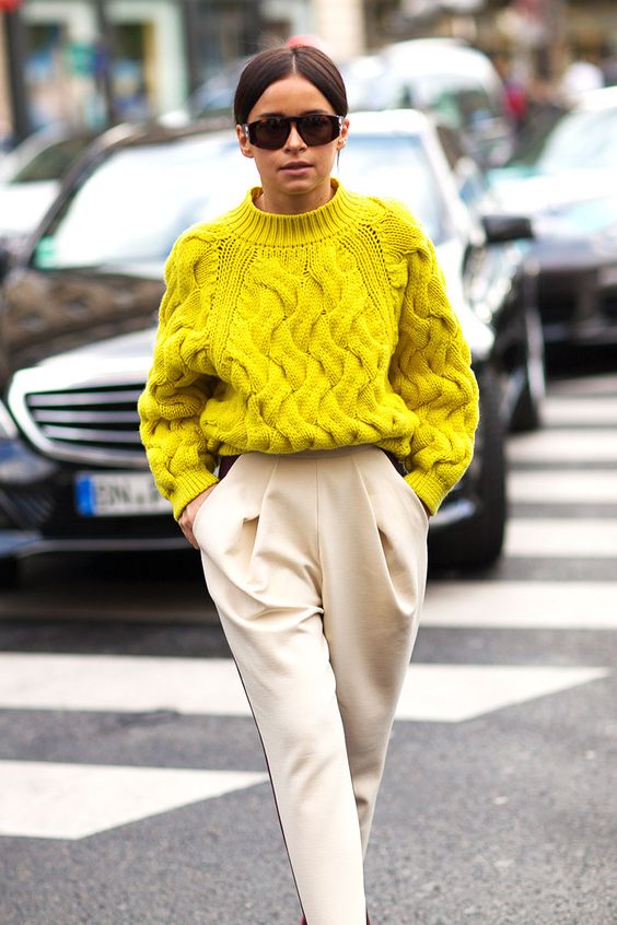 a lemon yellow chunky knit sweater and creamy pants with pockets