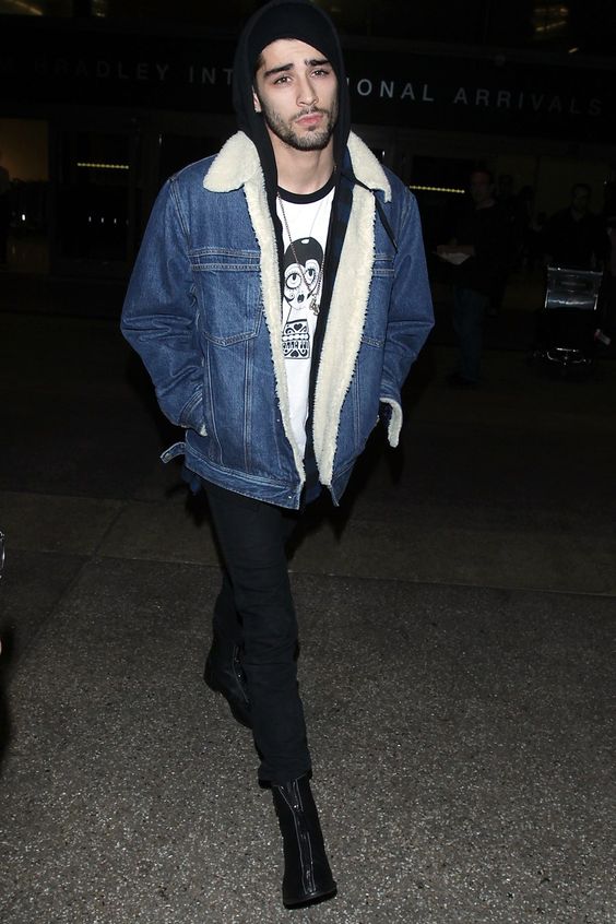 black jeans, a printed tee, a hoodie, a denim shearling coat and boots