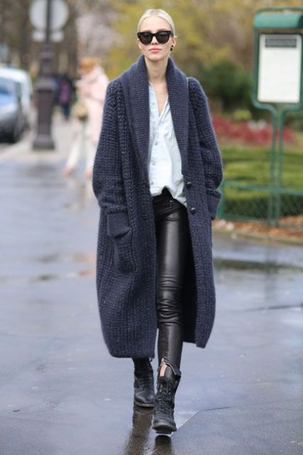 black leather pants, a white shirt, black boots and an extra long navy cardigan