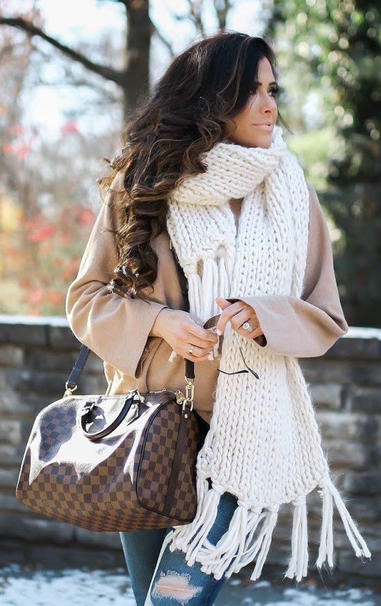 a creamy chunky knit scarf over a short camel coat for a stylish look