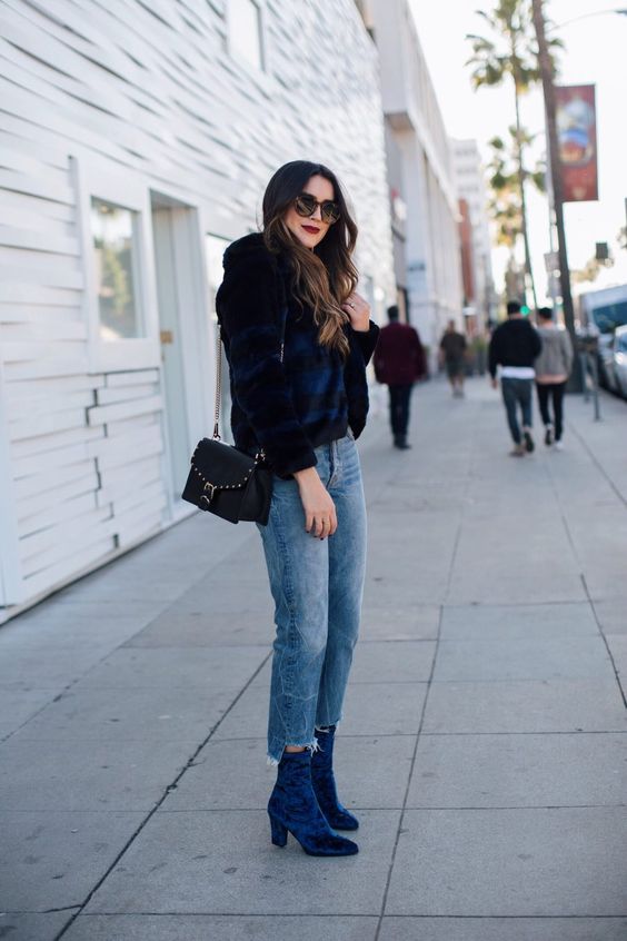 a navy and black striped cropped fur coat, distressed denim and crushed velvet sock boots