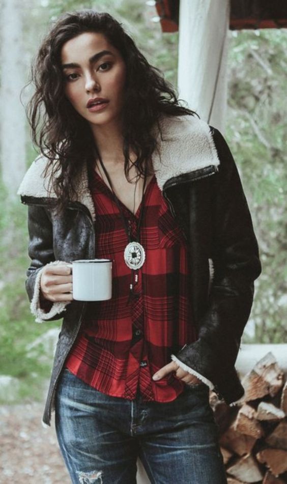 a plaid shirt, blue jeans and black and white shearling coat for winter