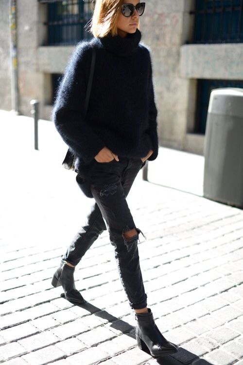 ripped black jeans, black boots and an oversized black angora sweater