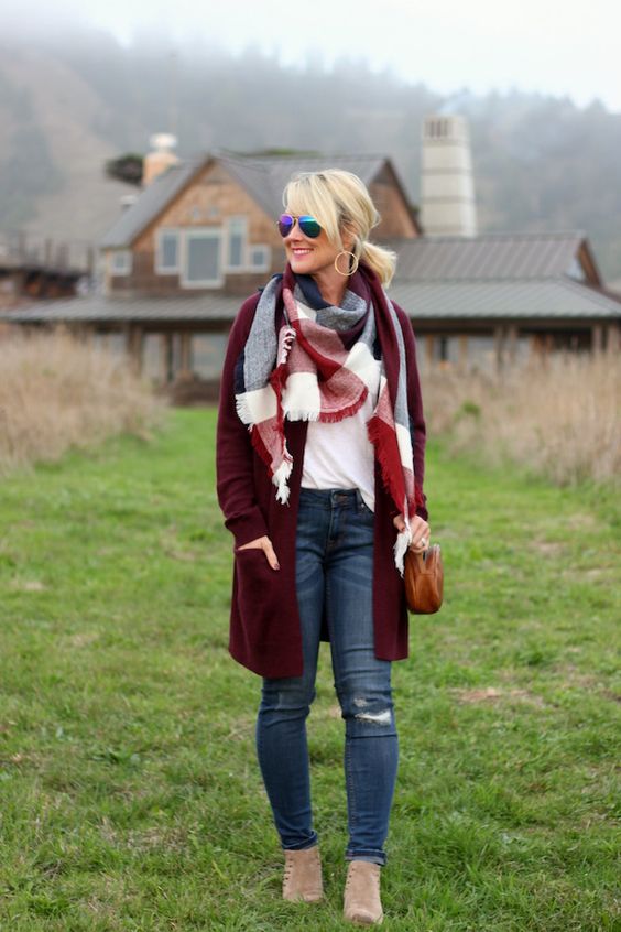 ripped jeans, a white top with long sleeves, a burgundy long cardigan and neutral booties