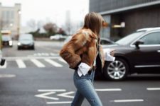 11 a white shirt, a black jacket, a faux fur coat, cropped jeans and white sock boots with kitten heels