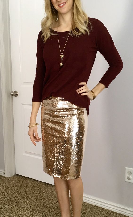a burgundy sweater, a gold sequin pencil skirt and a gold statement necklace
