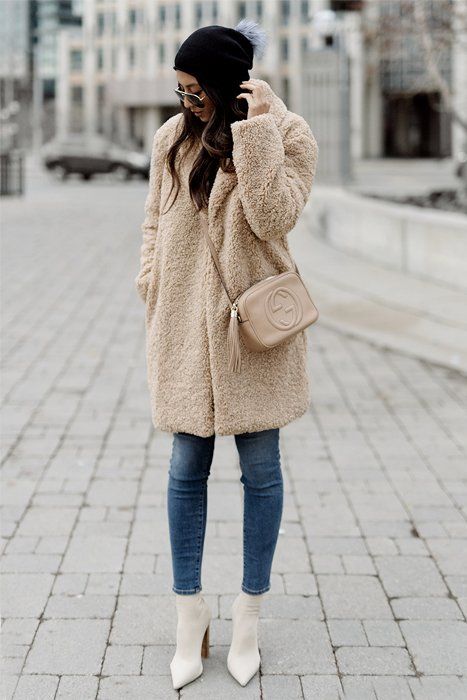 cropped jeans, a faux fur fuzzy coat, creamy sock boots and a beanie
