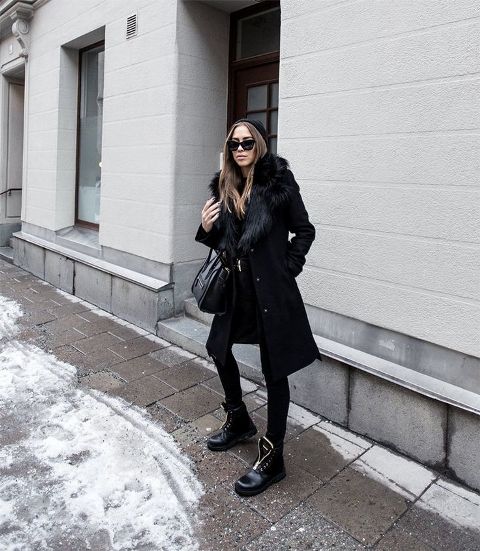 Black coat with fur, skinny pants, lace up boots, bag and beanie