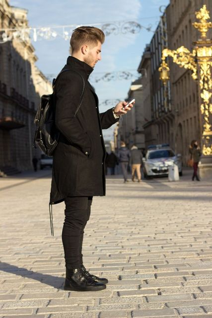 Black parka with leather backpack, skinny pants and lace up boots