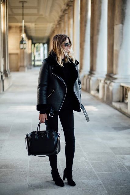 Black shearling jacket with skinny pants, high boots and leather bag