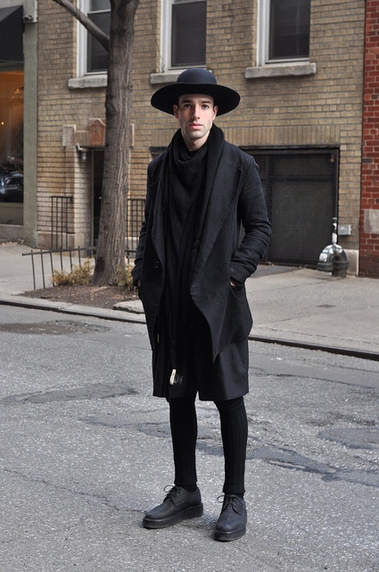 Black wide brim hat, scarf, loose coat, skinny pants and platform shoes