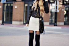 With black hat, white mini skirt, jacket and crossbody bag