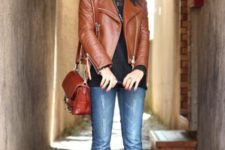 With black shirt, brown leather jacket, red bag and black boots