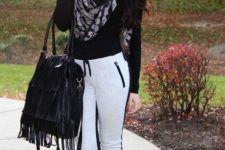 With black shirt, fringe bag, black boots and printed scarf