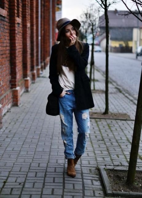 With blouse, brown boots, wide brim hat and black coat