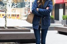 With gray beanie, skinny jeans, brown ankle boots, beige bag and brown sweater
