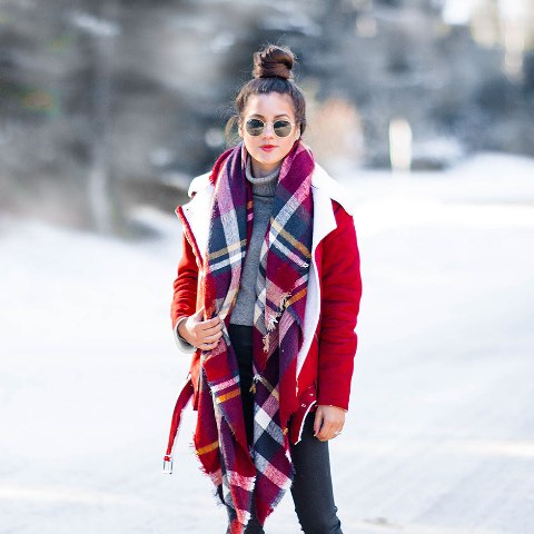 With gray turtleneck, jeans and red shearling jacket