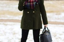 With green coat, black pants, ankle boots and black bag