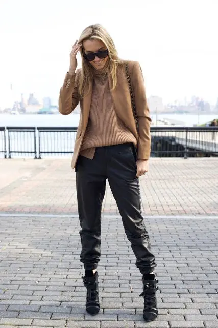 With loose sweater, camel jacket and black boots