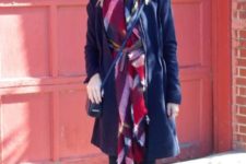 With navy blue coat, beige hat, crossbody bag and brown high boots