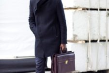 With navy blue coat, trousers, purple bag, red socks and black shoes