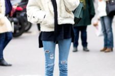 With navy blue shirt, white fur jacket and skinny jeans