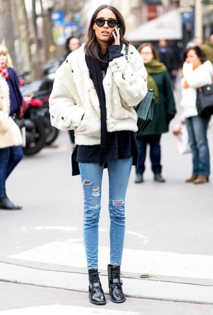 With navy blue shirt, white fur jacket and skinny jeans