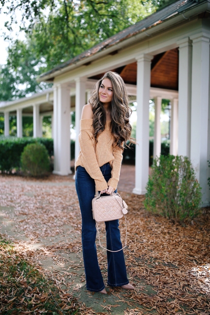 With off the shoulder sweater, beige boots and pale pink bag