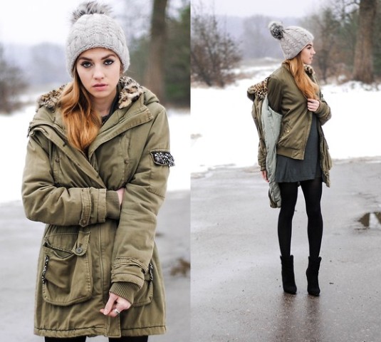 With olive green jacket, gray dress, mid calf boots and gray beanie