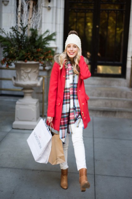 With red fur parka, white beanie, white pants and brown ankle boots