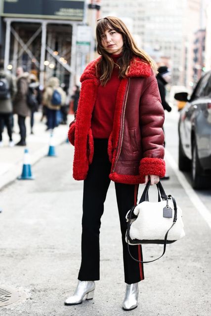 With red turtleneck, shearling jacket, flare trousers and black and white bag