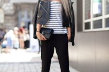 With striped shirt, black leather jacket, black boots and clutch