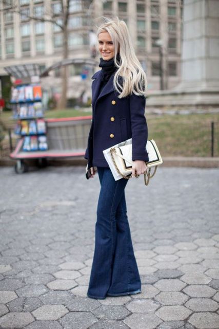 With turtleneck, navy blue jacket and white clutch
