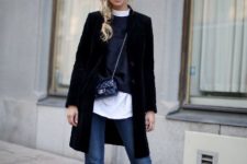 With white shirt, sweater, black coat, mini bag and mid calf boots