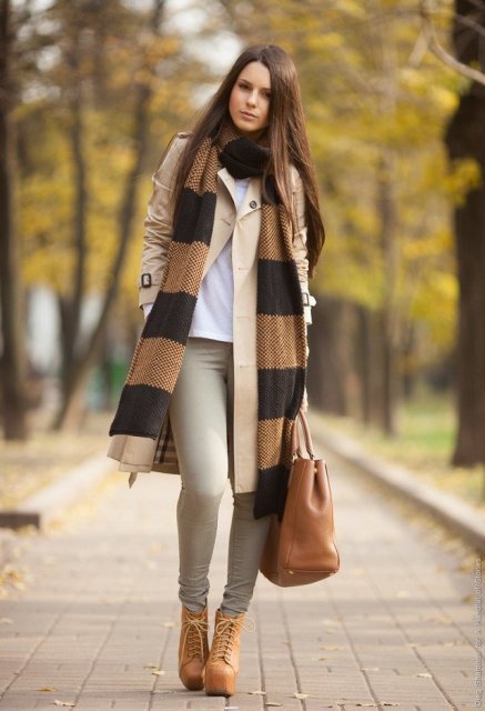 With white t-shirt, beige coat, light gray pants, brown leather tote and printed scarf