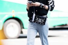 With white t-shirt, gray pants, printed sneakers and embellished bag