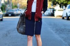 With white t-shirt, navy blue skirt, marsala boots and black bag