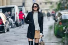 With white turtleneck sweater, mini skirt and coat