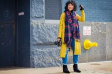 With yellow coat, cuffed jeans and black ankle boots