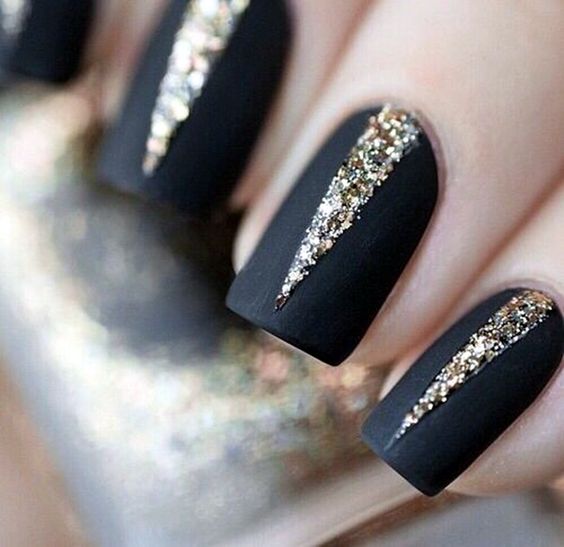 matte black nails with gold glitter geometric detailing with a wow factor