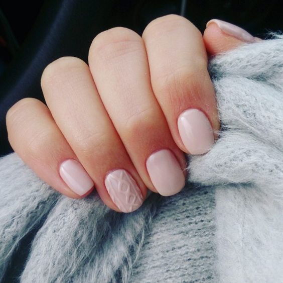 neutral nails with a cable knit accent nail is a fresh winter take on a nude manicure