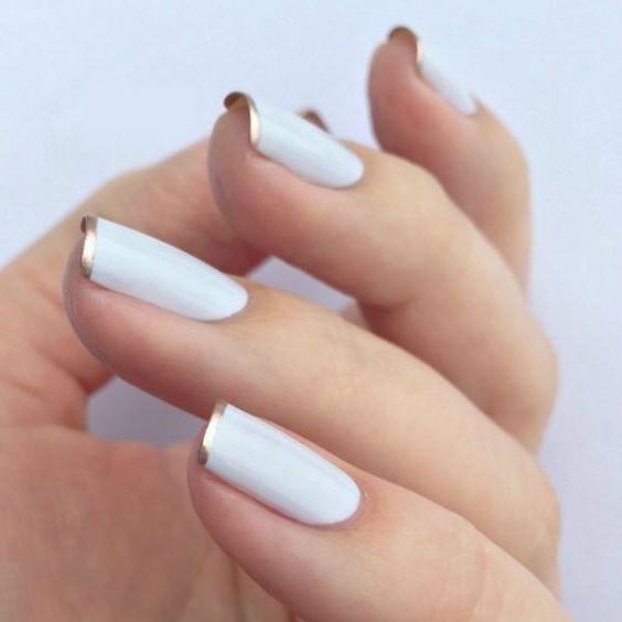 white nails with a gold rim is a fresh take with a metallic shade