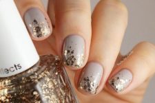 05 dove grey manicure with gold glitter hexagons for a chic festive look