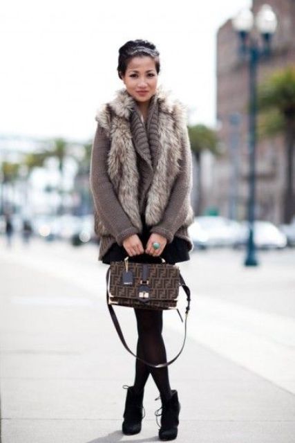 a brown sweater, a faux fur vest, a black mini and black suede booties