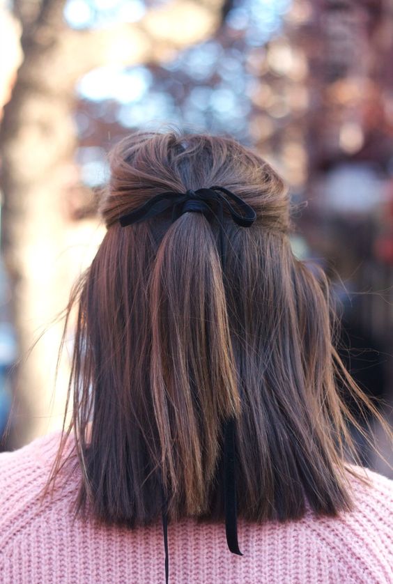 a half updo with a black velvet ribbon is a refined idea
