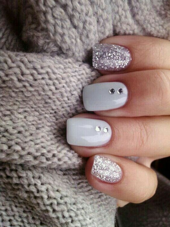 silver glitter nails with white ones dotted with rhinestones for a sparkly touch