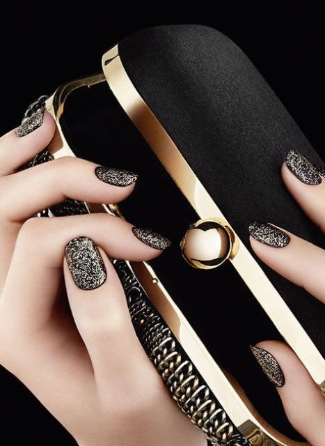 black manicure with gold glitter touches all over for a refined look
