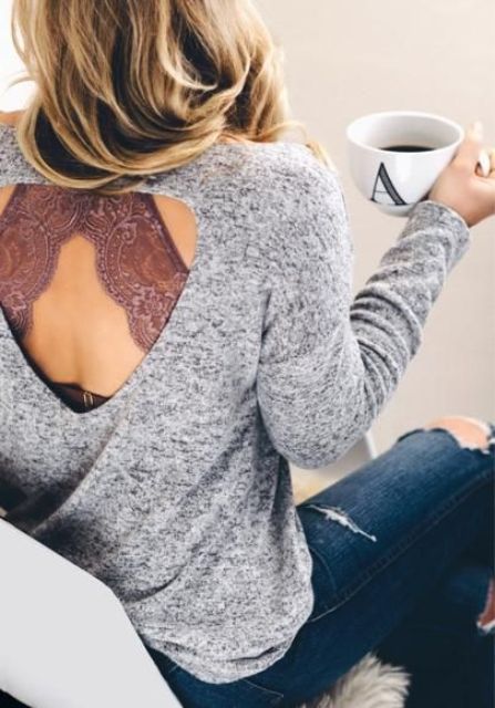 ripped blue denim, a grey cutout sweater and a dusty pink bralette