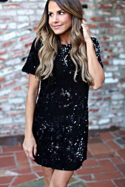 a black sequin mini dress with short sleeves is holiday take on a LBD